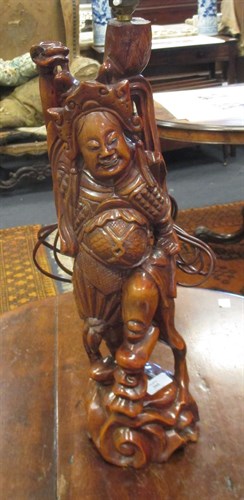 Lot 395 - A carved Eastern hardwood figural lamp, (base...