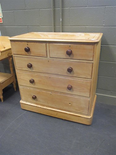 Lot 445 - A pine chest of drawers with crossbanded top...