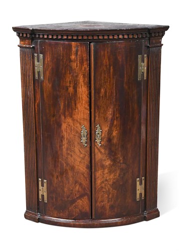 Lot 376 - A George III mahogany bow front corner cupboard
