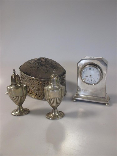 Lot 207 - A small silver clock with an enamelled dial;...