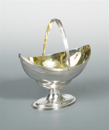 Lot 101 - A George III silver swing handled sugar basket by Peter and Ann Bateman