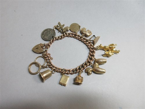 Lot 180 - A 9ct rose gold charm bracelet with padlock...