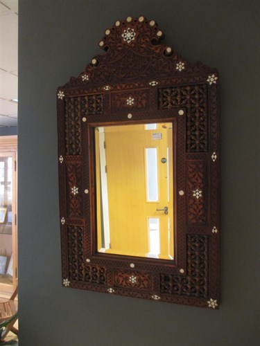 Lot 438 - An Islamic carved and inlaid frame wall mirror...