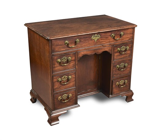 Lot 373 - An early George III mahogany kneehole desk