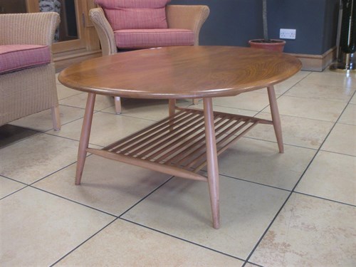 Lot 440 - An Ercol light elm oval occasional table with...
