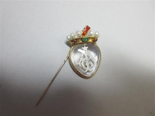 Lot 411 - A reverse carved rock crystal pendant set with a coronet of gems and enamel