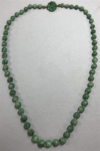 Lot 351 - A carved jade bead necklace