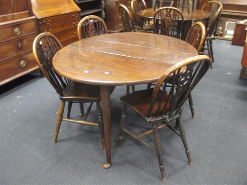 Lot 380 - An 18th century oak drop leaf table and four...