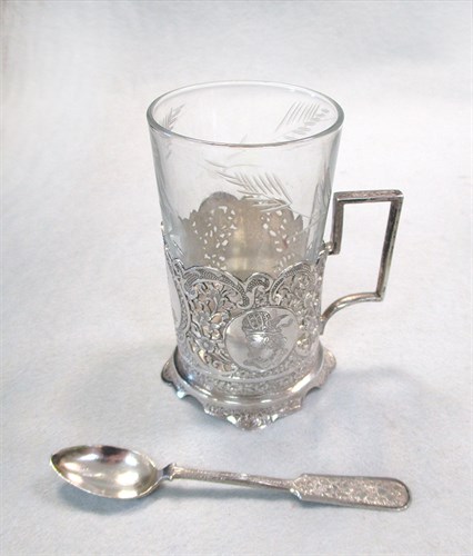Lot 16 - A Middle Eastern tray with six podstakanniks, spoons and a pair of tongs
