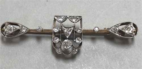 Lot 303 - A diamond set bar brooch of unusual pierced shield and teardrop form