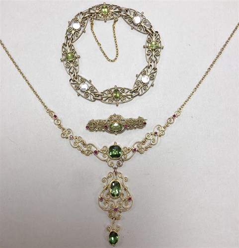 Lot 379 - A green tourmaline and ruby filigree necklace with matched peridot and ruby brooch, and a peridot and mother-of-pearl bracelet