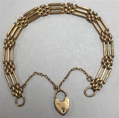 Lot 128 - A gatelink bracelet with padlock catch, and...