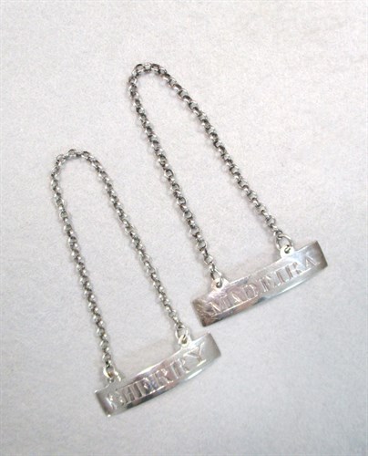 Lot 106 - Two Georgian silver decanter labels