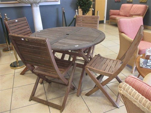 Lot 441 - A folding teak garden table and four matching...