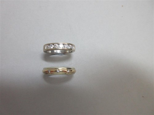 Lot 389 - Two gold and diamond band rings