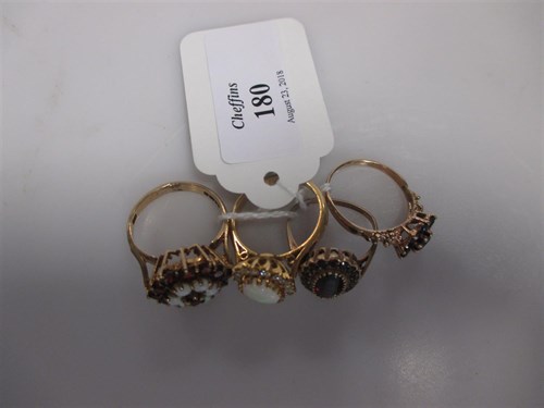 Lot 180 - An opal cluster ring set in hallmarked 18ct...