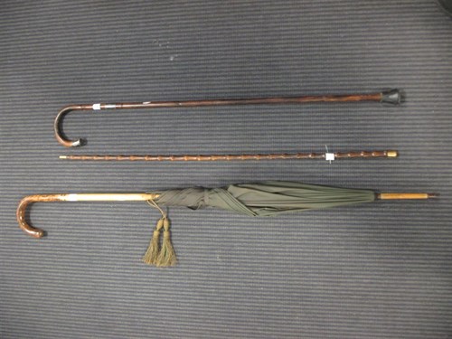 Lot 145 - A faux bamboo walking stick with 18ct gold top,...