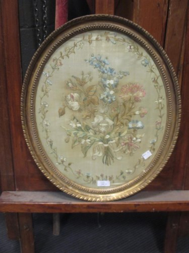 Lot 246 - An early 19th century oval silkwork picture...