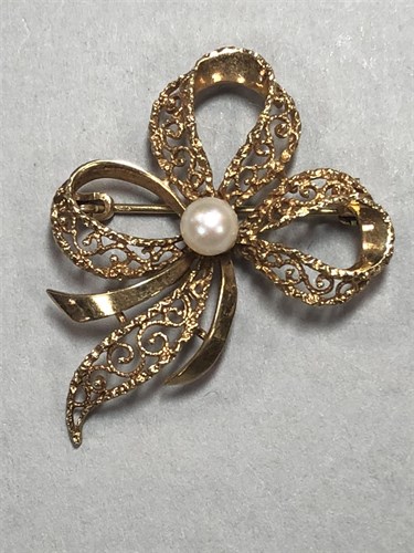 Lot 310 - A gold and cultured pearl  brooch by Andreas Daub together with a two row cultured pearl necklace