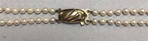 Lot 310 - A gold and cultured pearl  brooch by Andreas Daub together with a two row cultured pearl necklace