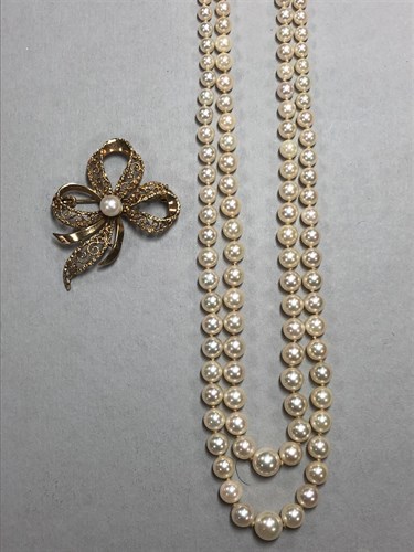 Lot 310 - A gold and cultured pearl  brooch by Andreas Daub together with a two row cultured pearl necklace