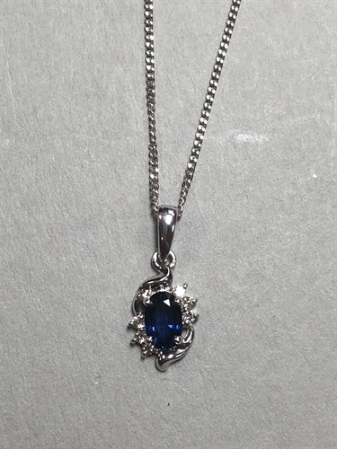 Lot 173 - A sapphire and diamond pendant and chain in...