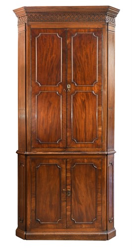 Lot 405 - A George III mahogany corner cupboard