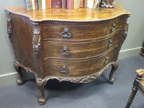 Lot 433 - A Chippendale revival serpentine mahogany...