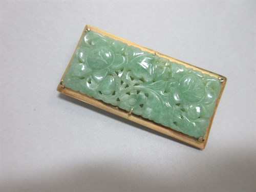 Lot 172 - A carved jade plaque brooch, the pierced...