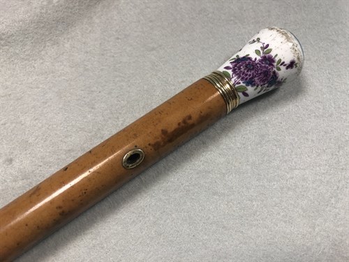Lot 326 - A 19th century malacca walking cane with a Continental porcelain handle