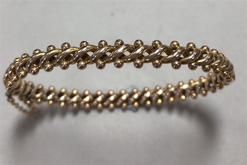 Lot 344 - A fancy twist hinged bangle
