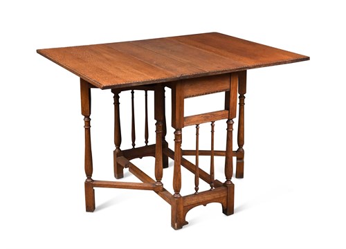 Lot 214 - An Arts & Crafts oak drop leaf table, 74 x 76...