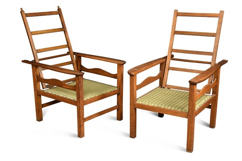 Lot 220 - After C.F.A. Voysey, a near pair of Heal's oak reclining chairs, circa 1905
