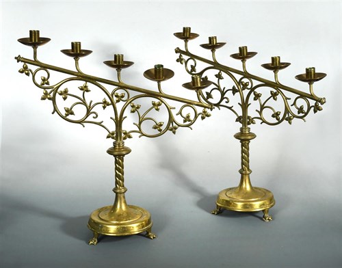 Lot 140 - A pair of Gothic brass altar candlesticks