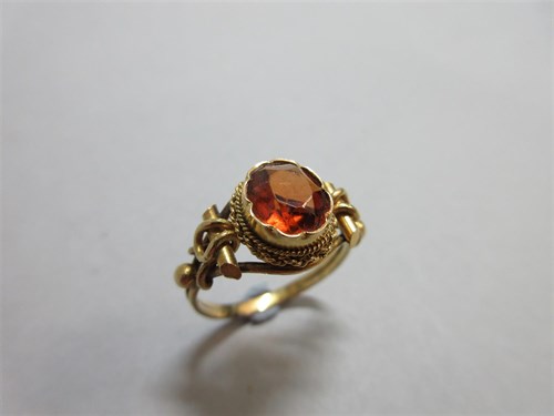 Lot 180 - A single stone hessonite garnet ring, the oval...