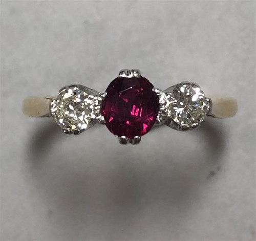 Lot 445 - A ruby and diamond three stone ring