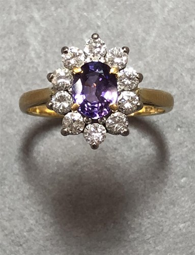 Lot 431 - A purple sapphire and diamond cluster ring set in 18ct gold