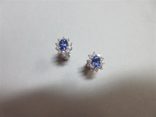 Lot 405 - A pair of tanzanite and diamond cluster earstuds