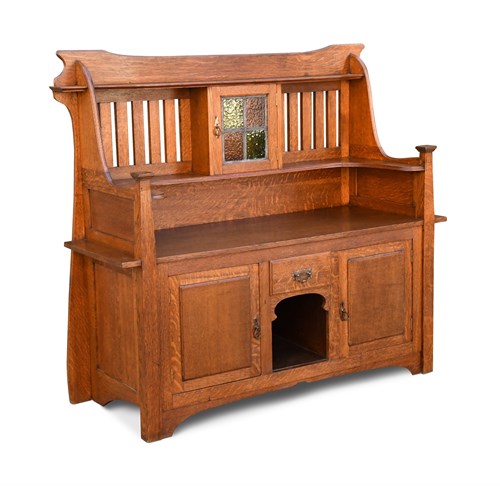Lot 218 - An Arts & Crafts oak dresser, the slatted back...