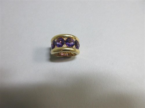Lot 418 - An unusual modern amethyst and diamond band ring set in 18ct gold