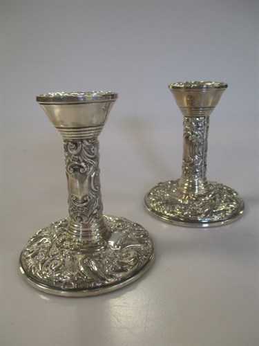 Lot 231 - A pair of filled silver dwarf candlesticks
