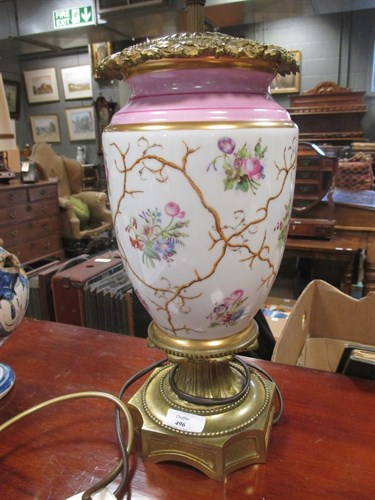 Lot 496 - A continental porcelain and gilt metal oil lamp
