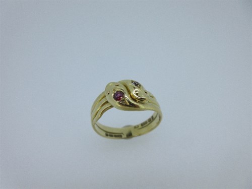 Lot 423 - A Victorian double snake ring set with a diamond and a ruby