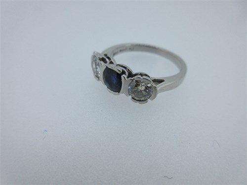 Lot 369 - A three stone sapphire and diamond ring set in platinum