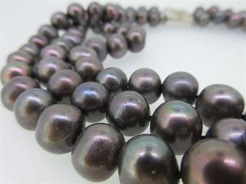 Lot 437 - A three row necklace of large cultured mink-coloured pearls