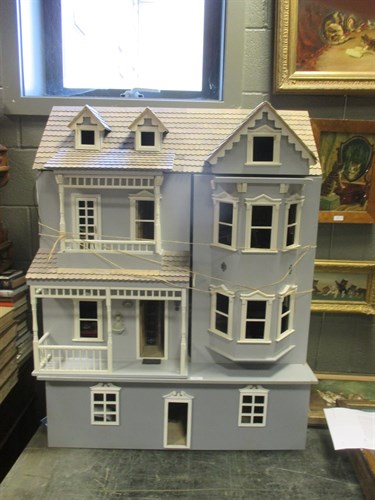 Lot 471 - A large dolls house, modelled as a three...