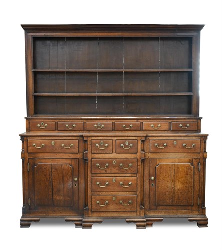 Lot 380 - A George III Anglesey oak breakfront dresser