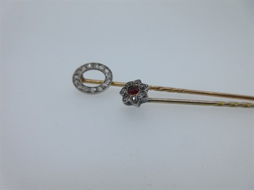Lot 382 - Two diamond set stick pins