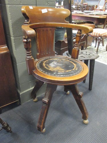 Lot 414 - A mahogany swivel desk chair with circular...