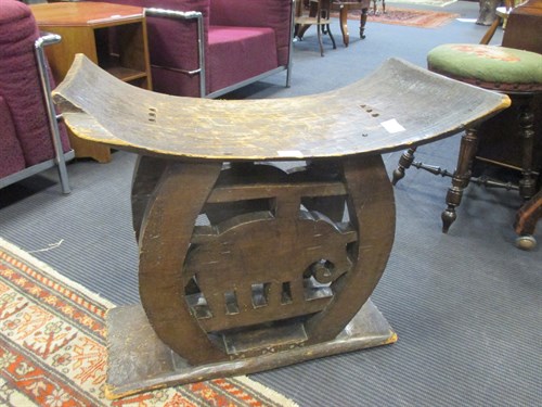 Lot 482 - An African carved wood stool with elephant motif
